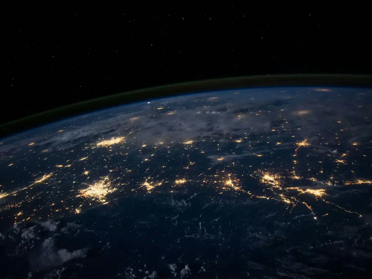 Night view of Earth showing city lights connected across continents