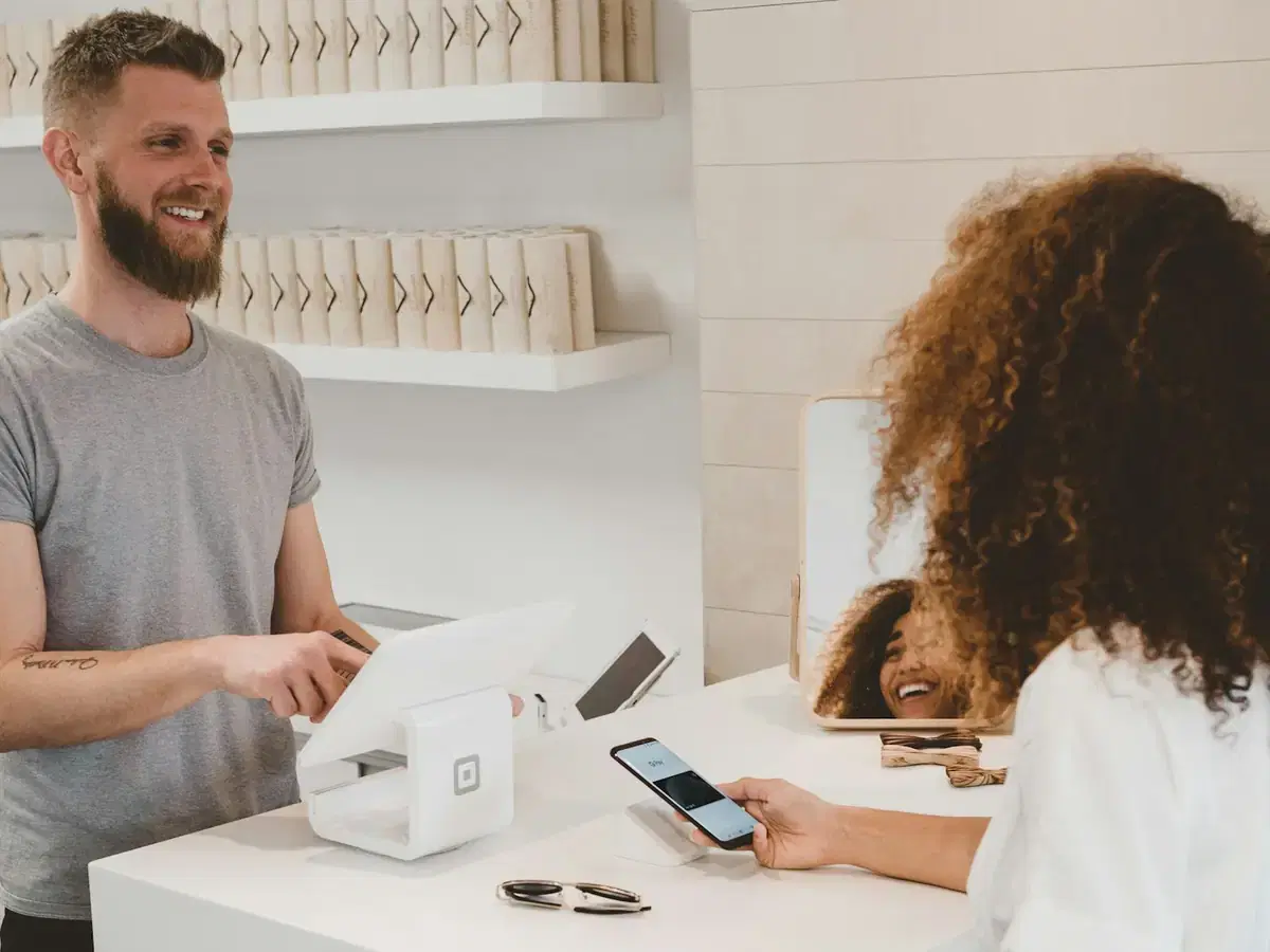 Customer paying with a phone at a shop counter